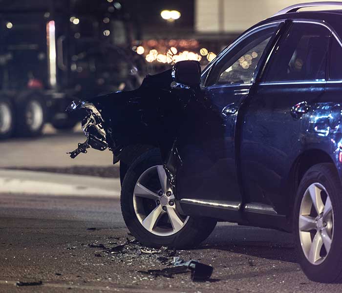 Drunk driving auto accident at night, front end collision on blue car