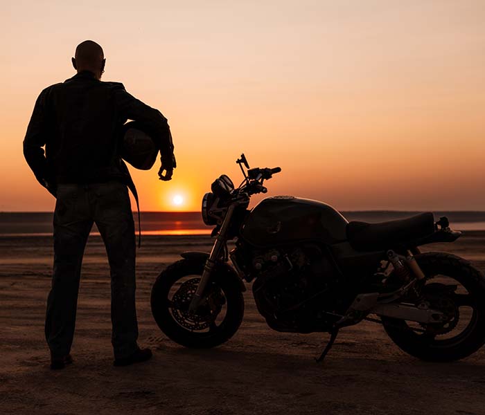 Motorcycle rider watching the sunset